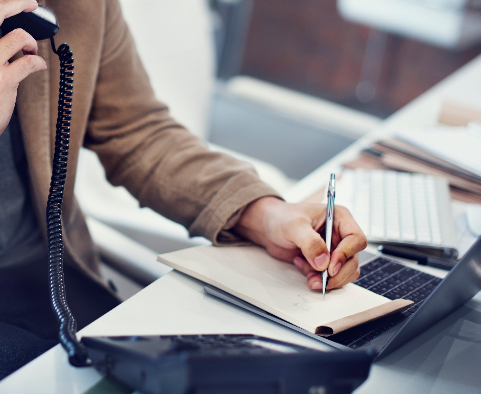 closeup-hand-writing-note-while-phone